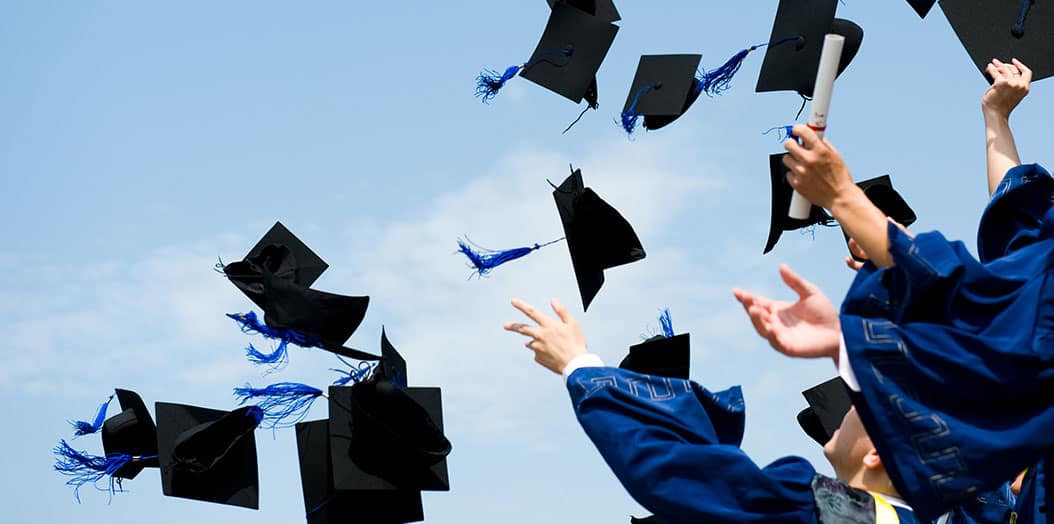 Graduation Students throwing caps.